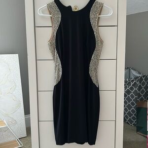 Black fitted homecoming/semiformal dress with beaded sides.